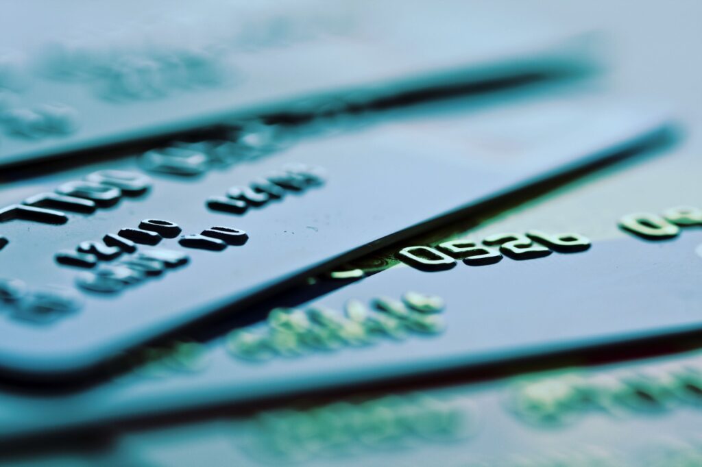 Gambar beberapa kartu debit dan kredit yang bertumpuk, melambangkan transaksi pembayaran yang aman